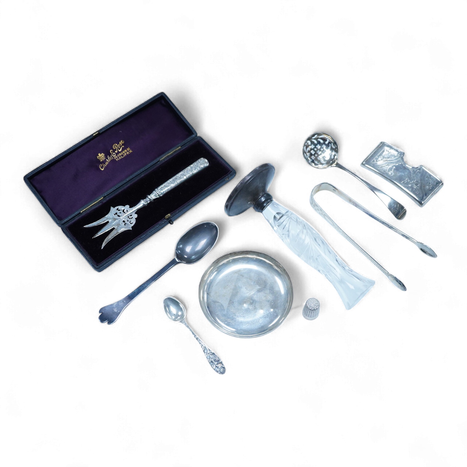 A collection of small silver to include a George V engraved concave card case, I. S. Greenberg & Co, Birmingham, 1912, 80mm, a cased late Victorian small bread fork, a modern mounted glass posy vase, an Irish nut dish, a